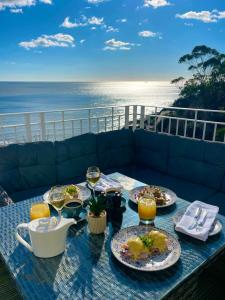 a table with plates of food and glasses of wine at The Wellington Hotel in Ventnor