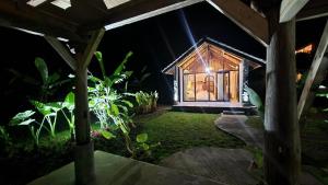 a small house with a window in a garden at night at Villa Neka in Luk