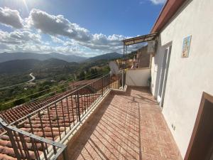 a balcony of a building with a view of the mountains at Umberto primo rooms in Castelbuono