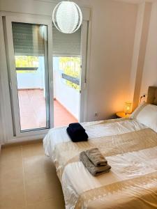 Un dormitorio con una cama con toallas. en Casa Helen Las Terrazas de la Torre - Blue Sky Property, en Murcia