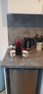 a counter top with two cups and a bag at Studio GIVRY in Givry