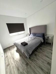 a bedroom with a bed and a window at Cute Amazing Palace in Guildford