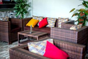 a living room with a couch with colorful pillows at BWIRANDA HOTEL in Kasese