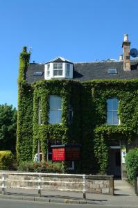 an ivy covered building with a window on top at A-Haven Townhouse Hotel in Edinburgh