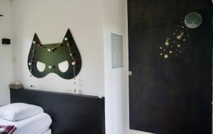 a bedroom with a black mask on the wall at Au bord de l'eau in Tendu +82 photos