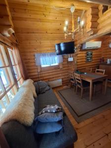 a living room with a couch and a dining room at Rantarinne 543 B in Kuusamo