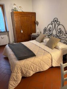 a bedroom with a large bed with a black frame at Home sweet home in San Gimignano +28 photos