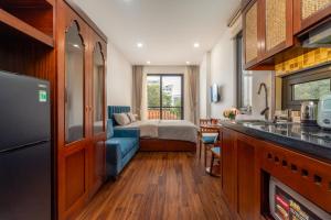 a kitchen and a bedroom with a bed in a room at Evelyn Indochine Chic in Central Hanoi in Hanoi