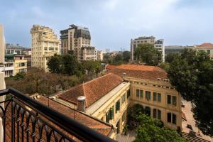 a view of a building in a city with tall buildings at Evelyn Indochine Chic in Central Hanoi in Hanoi