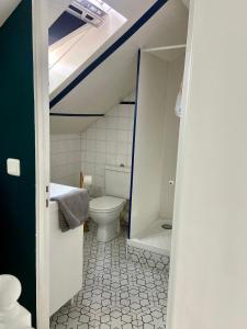 a bathroom with a toilet and a sink at Villa Yollande in Arcachon