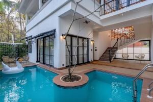 a swimming pool in a house with a house at Wadi House - Lux 3BR Villa in Siolim, 4km to beach in Siolim