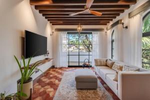 a living room with a couch and a ceiling fan at Wadi House - Lux 3BR Villa in Siolim, 4km to beach in Siolim
