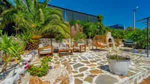 een patio met meubilair en planten in een tuin bij Villa CANAN in Kas
