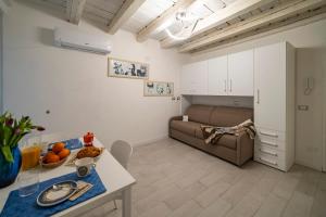 a living room with a couch and a table at MagentA NesT - Loft&Charme in Brescia +15 photos