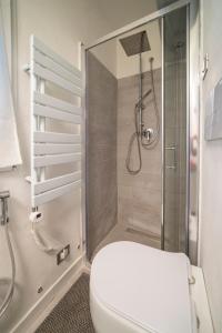 a bathroom with a toilet and a glass shower at MagentA NesT - Loft&Charme in Brescia