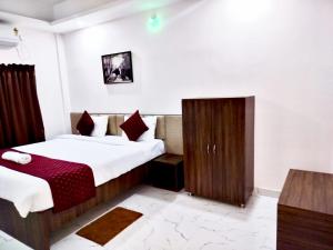 a hotel room with two beds and a cabinet at Divine Homestay in Siliguri