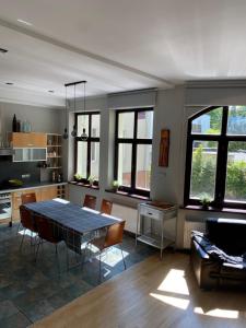 a kitchen with a table and chairs in a room at Sopot Lodge in Sopot