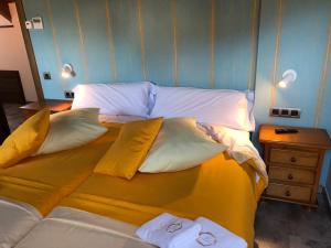 a large bed in a room with two pillows at Casa FOR HABITACIONES in Labuerda