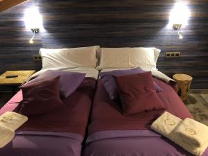 a large bed with pillows on it in a room at Casa FOR HABITACIONES in Labuerda +23 photos