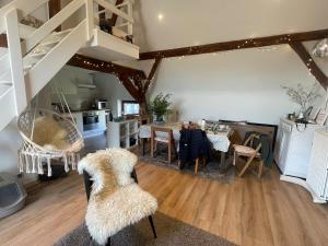 a kitchen and dining room with a table and a staircase at Petit duplex cosy coup de coeur, dans ferme de charme du 18 è siècle au milieu des champs in Bossut-Gottechain +9 photos