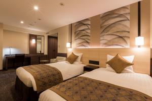 Postel nebo postele na pokoji v ubytování Matsue Excel Hotel Tokyu