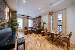a living room with a table and a couch at Arctic Boutique Hotel in Korçë