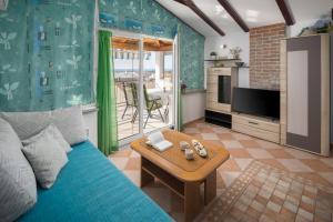 a living room with a blue couch and a table at Villa Tina Porec in Poreč