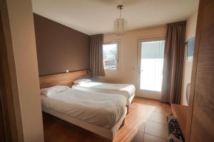 Postel nebo postele na pokoji v ubytování Residence Les Chataigniers