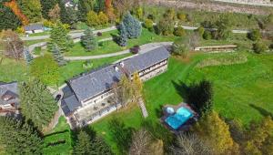 an aerial view of a house with a train on a field at Hotel Els Avets in Sorpe