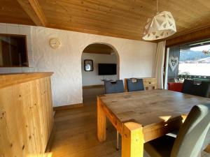 a dining room with a wooden table and chairs at Chalet Fleur des Alpes 2 in Les Gets