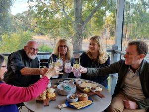 a group of people sitting around a table with wine glasses at Lavender Cottage at Nannup Lavender Farm in Nannup +9 photos