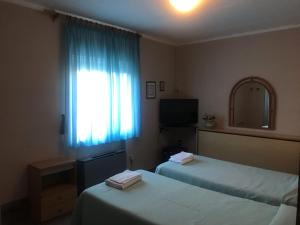Odec Hotel في ألتوباشو: غرفة فندق بها سريران ونافذة