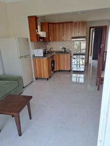 a kitchen with a couch and a refrigerator at jo sunny lakes in Sharm El Sheikh