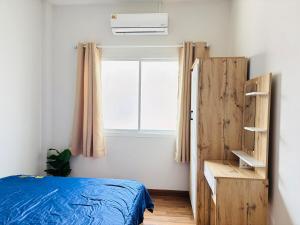 Ένα ή περισσότερα κρεβάτια σε δωμάτιο στο Muanjai House