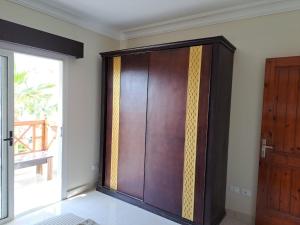a large wooden door in a room with a window at jo sunny lakes in Sharm El Sheikh +2 photos