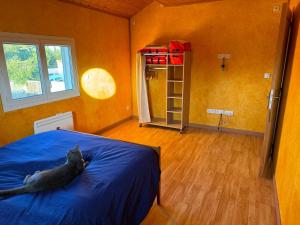 a cat laying on a bed in a bedroom at Maison in Chatuzange-le-Goubet