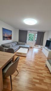 a living room with a couch and a table at Simple Stay Pulheim in Pulheim +2 photos
