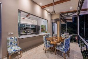 a dining room with a wooden table and chairs at Ocean View Villa With Pool and Spectacular Sunsets in Ballena
