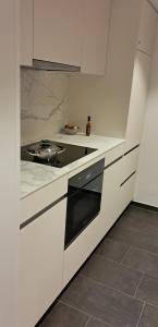 a white kitchen with a stove top oven in it at Helvetia 2005 Sr 2-ZW 2 Stock in Lenzerheide