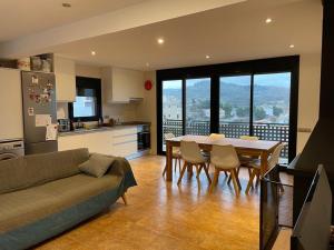 a kitchen and dining room with a table and chairs at Ulldemolins Niuet in Ulldemolins +42 photos