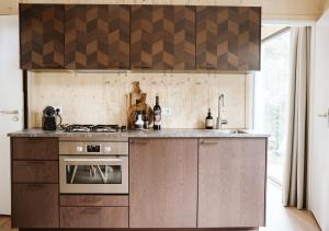 a kitchen with a stove and a counter top at Tinyhouse NaNo in Nunspeet