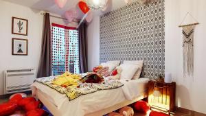 a bedroom with a bed with stuffed animals on it at Suite climatisée, 2 personnes in Montry