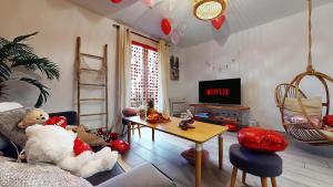 a living room with a teddy bear sitting on a couch at Suite climatisée, 2 personnes in Montry