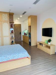 a bedroom with a bed and a flat screen tv at SP Sky OASIS 27 06 QuynhDao HomeStay in Kim Quan