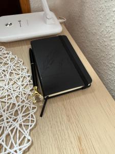 a notebook sitting on top of a wooden table at Sweet dreams in Blankenfelde