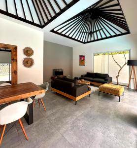 a living room with a couch and a table at Luxury at Family Ties Villa in Gili Air