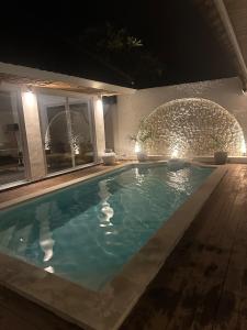 a swimming pool in a house at night at Luxury at Family Ties Villa in Gili Air