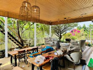 an outdoor patio with tables and chairs and a staircase at Villa 1 , Phường 2 ngay trung tâm thành phố bảo lộc in Bao Loc