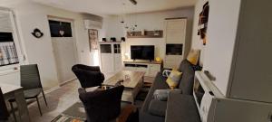 a living room with a couch and a table at Schmuckkästchen Bungalow 50 in Dipperz