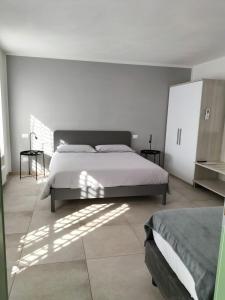 a white bedroom with a bed and a window at La casa della Ada in Castelnuovo del Garda +15 photos